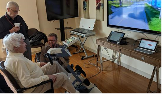 Elder woman cycling on a motiview technology