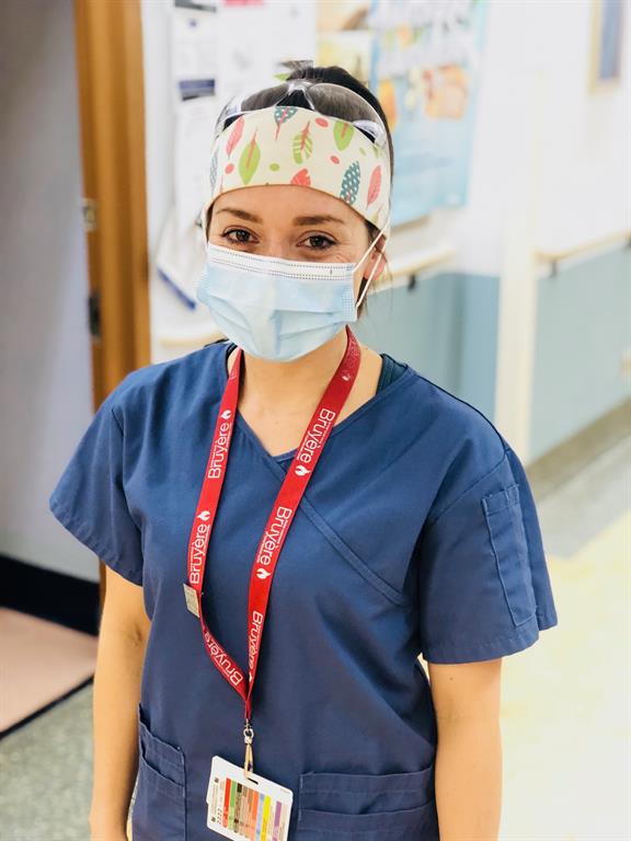 Health care provider smiling with mask on