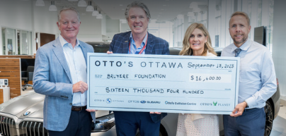 Otto's representatives presenting large cheque to Bruyère staff